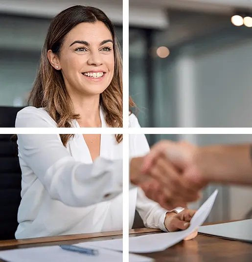 A woman shaking hands over papers in an office.